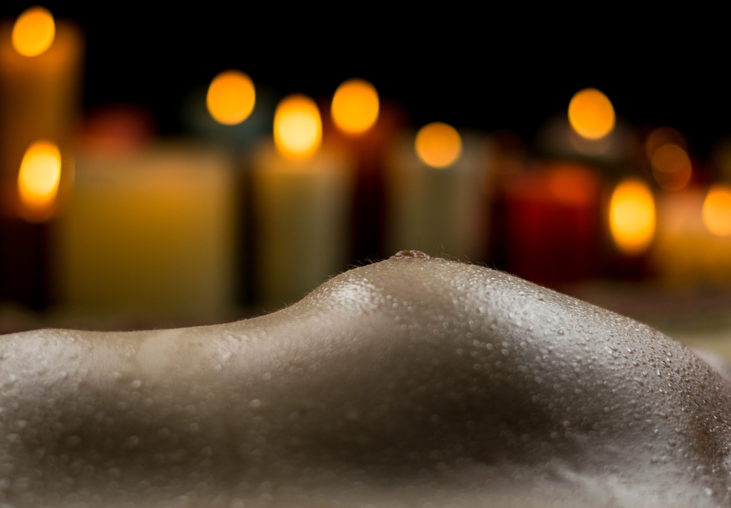 BadBoy Photography | Image of nude breasts with candles in the background. Boise, Idaho.